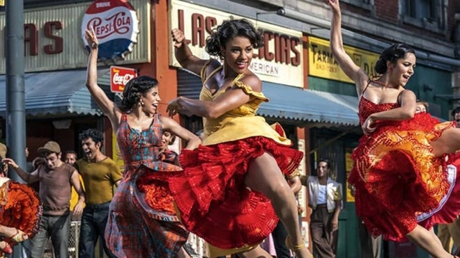 Promotional still featuring Ariana Debose dancing as Anita and two other actresses dancing in dresses behind her