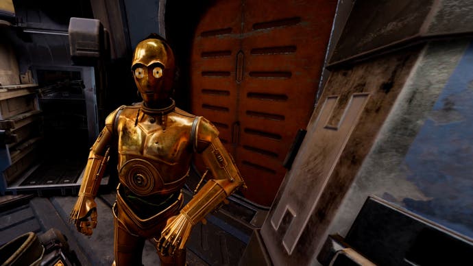 PSVR2 - C3PO looks at you in front of a red door inside an industrial looking corridor