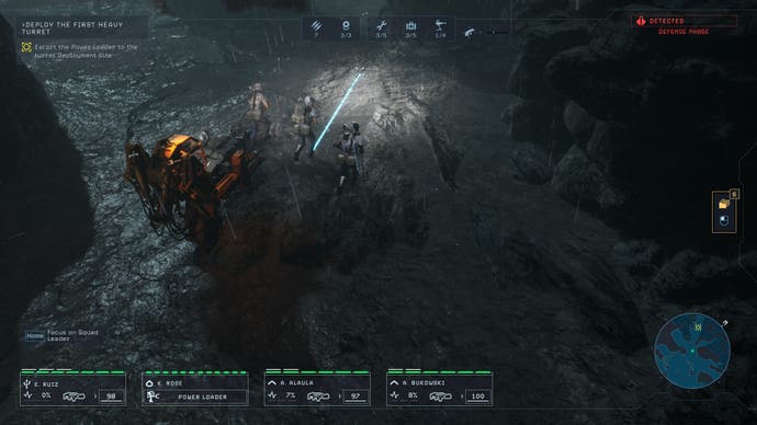 A scene from the planet Lethe’s surface in Tindalos Interactive’s Aliens: Dark Descent, showing the  player’s marine squad accompanying an orange robot powerloader through a barren landscape.