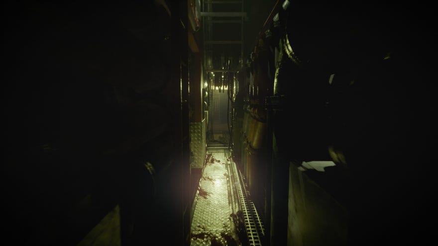 A dimly lit gap between two large mechanical fixtures in horror game Still Wakes The Deep