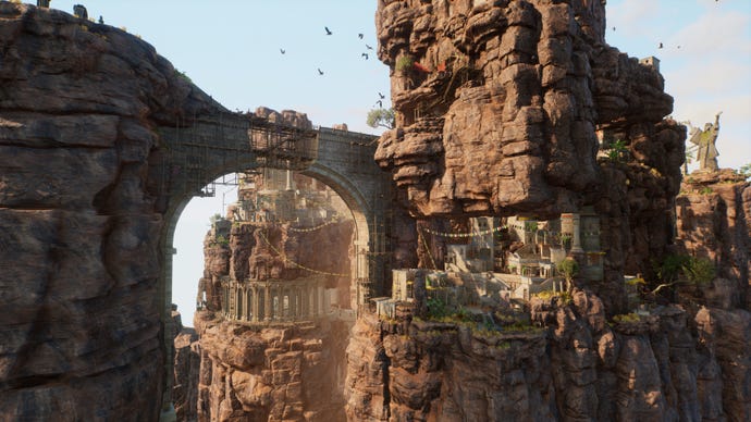 A sand bridge beneath an imposing cliffisde structure in Outcast: A New Beginning