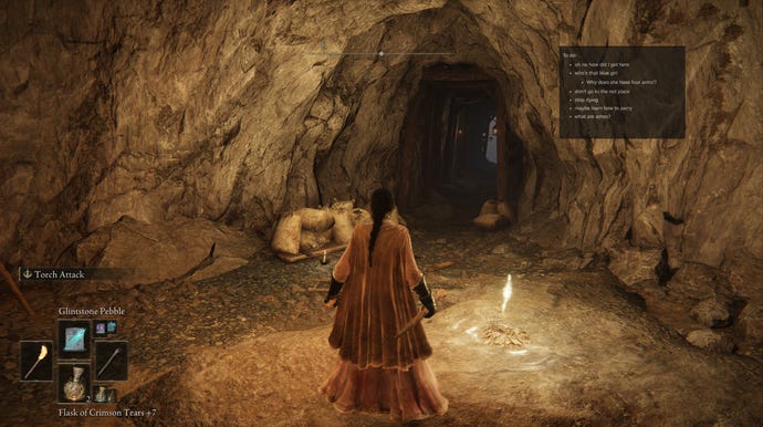 A screenshot of a warrior in Elden Ring in a cave with a new Steam window overlay pinned to the screen in the corner
