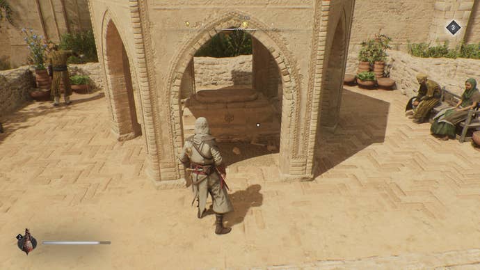 Basim faces a tombstone within a small stone gazebo, where an enigma can be found in Assassin's Creed Mirage