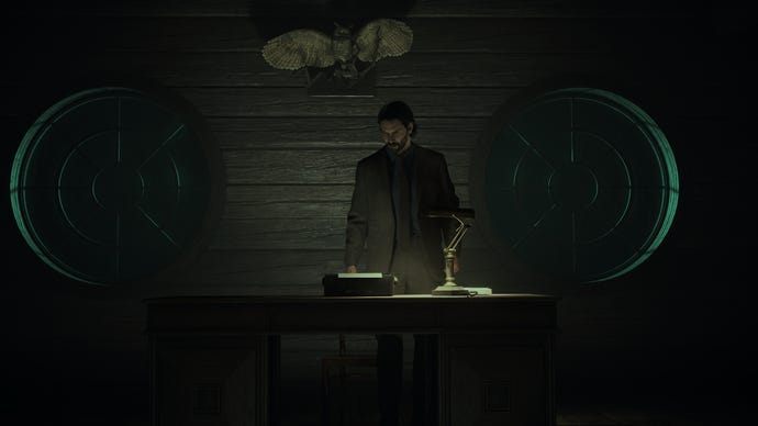 Alan stands at his writing desk in Alan Wake 2.