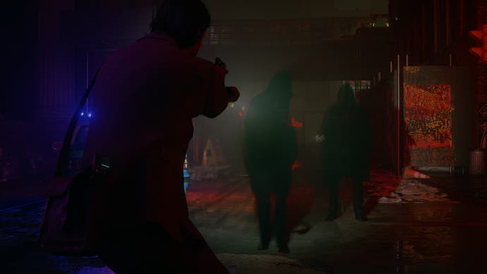 Alan Wake 2 screenshot showing a silhouette pointing a flashlight at another silhouette in the dark, with a red hue of light