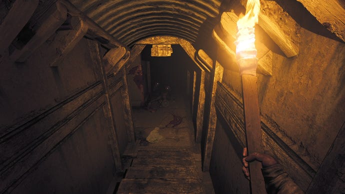 The player wields a torch while looking down a narrow corridor towards an enemy in Amnesia: The Bunker