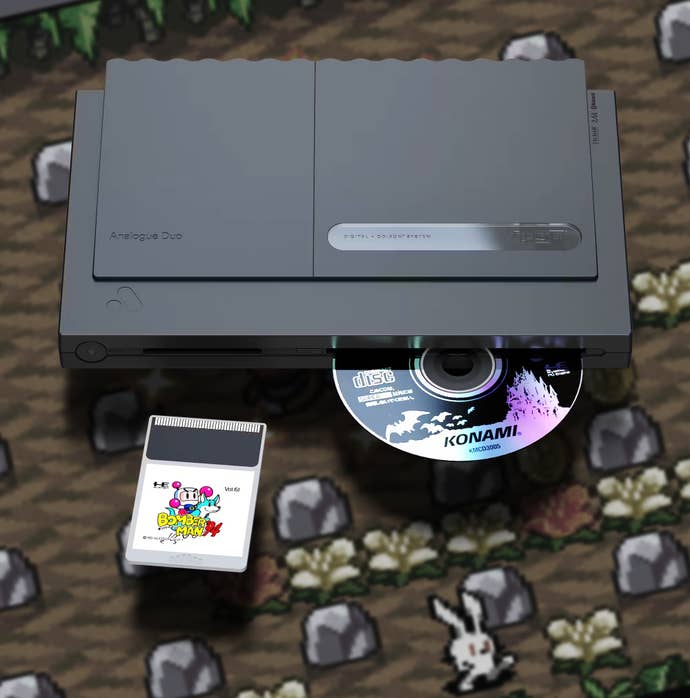 Analogue Duo, a disc popping out of a tray, and a Bomberman 94 cart with the Bomberman 94 in the background.