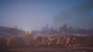 Multiple merchants travel on camels through a desert in Assassin's Creed Mirage