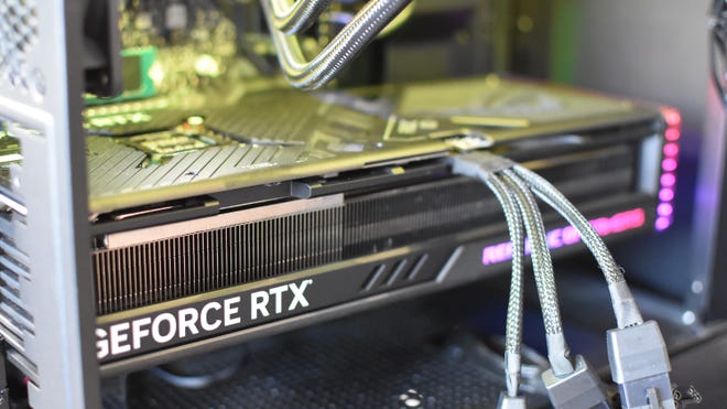 The Asus ROG Strix GeForce RTX 4080 OC Edition graphics card running inside a PC.