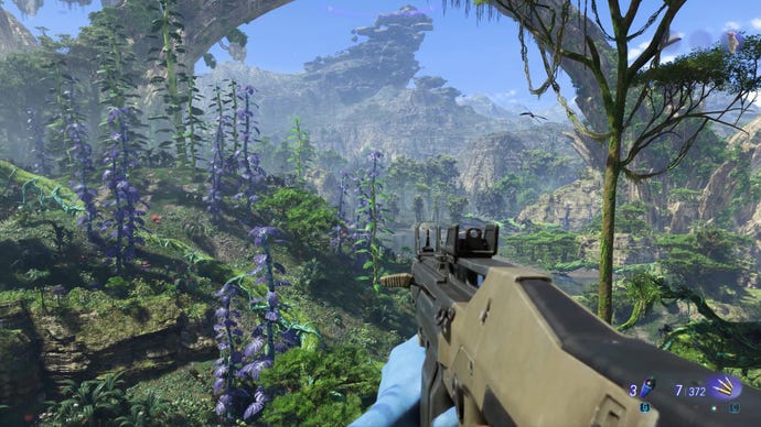 A vista of tall plants, a river and large mountains in Avatar: Frontiers Of Pandora