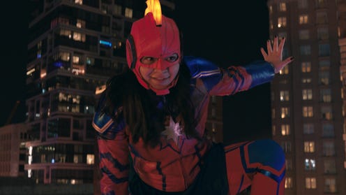 A young woman (Kamala Khan) on a rooftop in costume as Captain Marvel