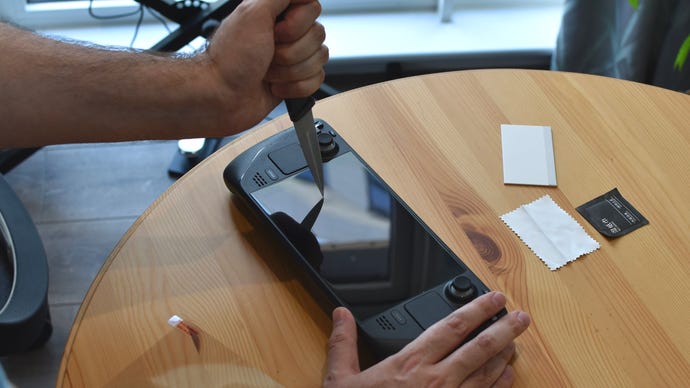 A knife being stabbed into a Steam Deck screen protector, to no effect.