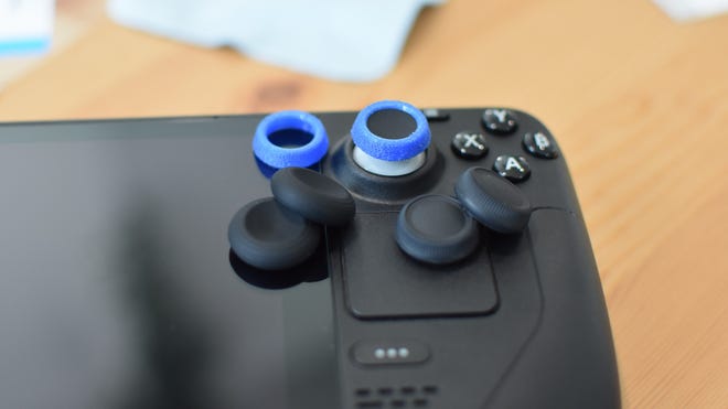Some of the best thumbstick covers for the Steam Deck, sitting on top of one.
