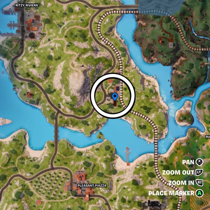 Cropped map view of a circle around a group of houses near a train track in Fortnite.