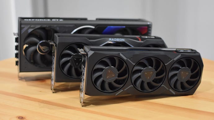 Several gaming graphics cards lined up on a desk.