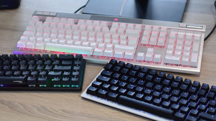 Various gaming keyboards on a desk.