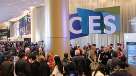 A bustling crowd moves below the CES 2024 entrance sign.