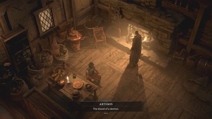 Inside a hunter's cabin, fire in a hearth illuminating the room. One figure sits at a table eating, another paces by the fire.