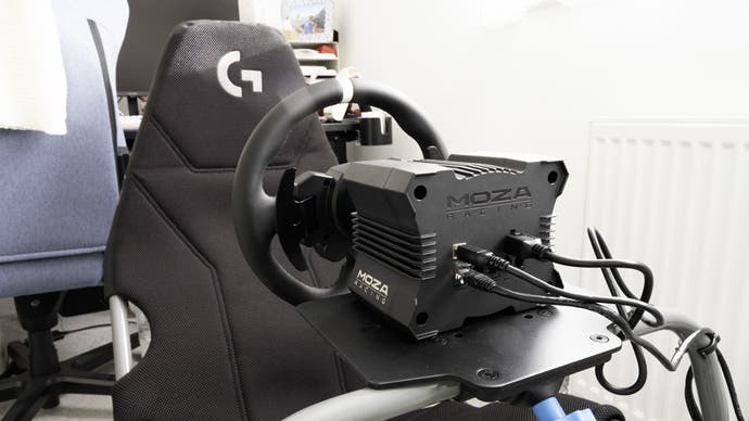 moza r5 bundle mounted on a playseat challenge x logitech g edition folding racing cockpit, viewed from the rear