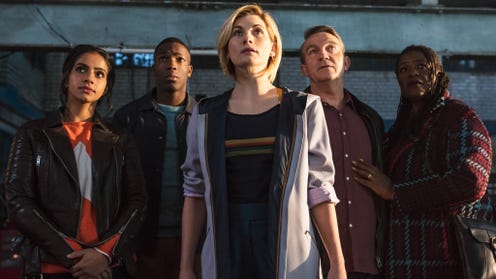 Image of Jodie Whittaker as the Doctor, with her companions behind her