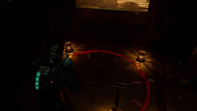 Isaac looks down at the ritual circle in the Break Room in Dead Space