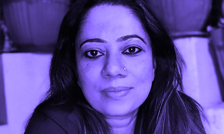 A potrait of Devaki Neogi, looking directly at the camera