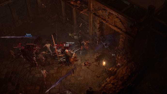 A Rogue fights demons in a dark room in Diablo 4.