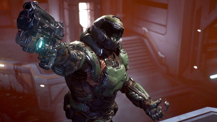 A screenshot from the finale of DOOM 2016, showing Doomguy triumphantly pointing his gun at the camera as if to say, 