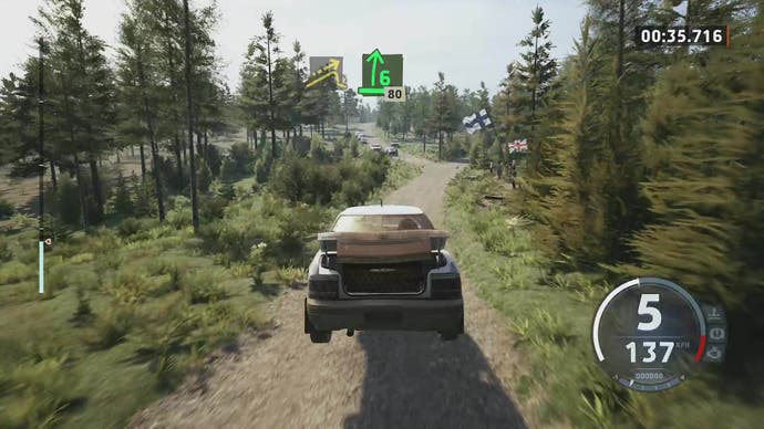 EA Sports WRC review 8: A shot of a dusty Subaru in the air, with its boot open, surrounded by trees.