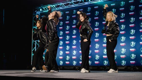 Photograph of fans dancing on stage