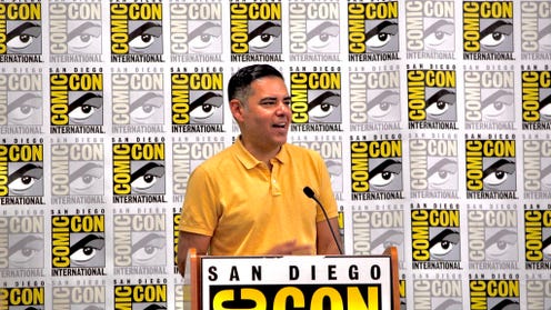 Photograph of Congressman Robert Garcia standing at a San Diego Comic Con podium