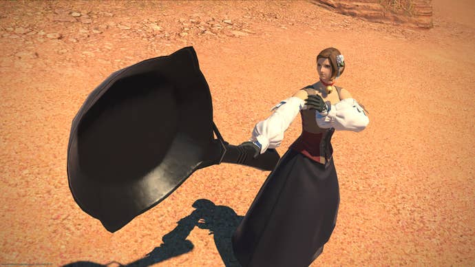 A massive frying pan, in the hands of a well-dressed human avatar in Final Fantasy 14.