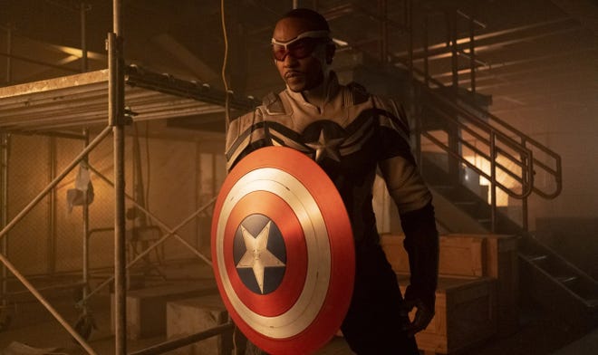 Sam Wilson in a Captain America suit holding the Captain America shield