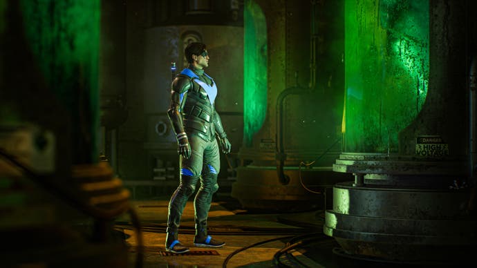 Gotham Knights preview - Nightwing stares at a tank of green fluid