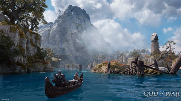 God of War preview - Kratos and boy paddle through steamy waters with a mountain in the background