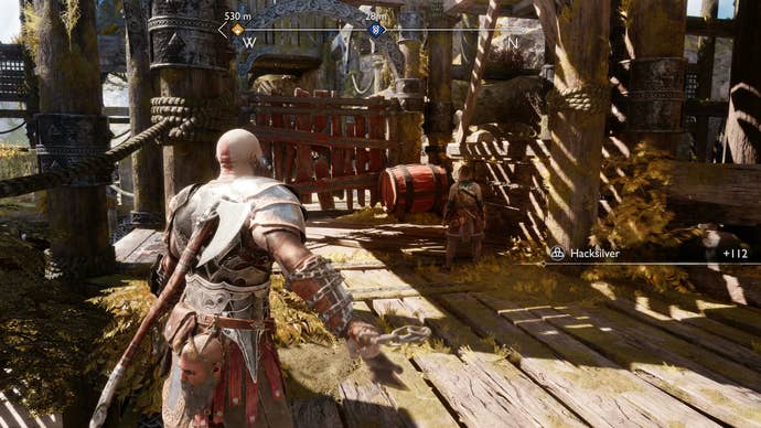 Kratos exploding a red barrel to create a path on Althjof's Rig in God of War Ragnarok