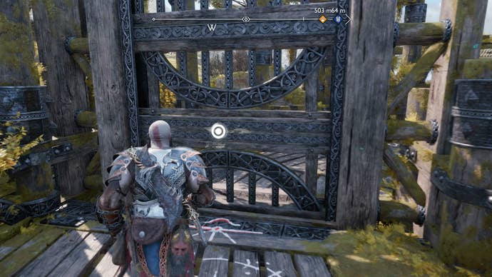 Kratos opening a large metal gate in God of War Ragnarok