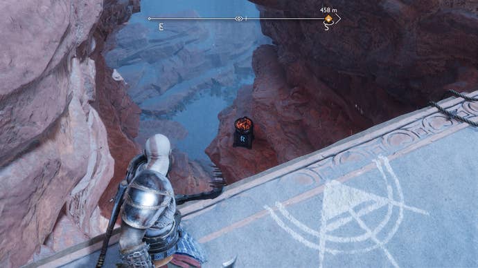 Kratos looking down at a brazier that unlocks a Nornir Chest in The Strond in God of War Ragnarok
