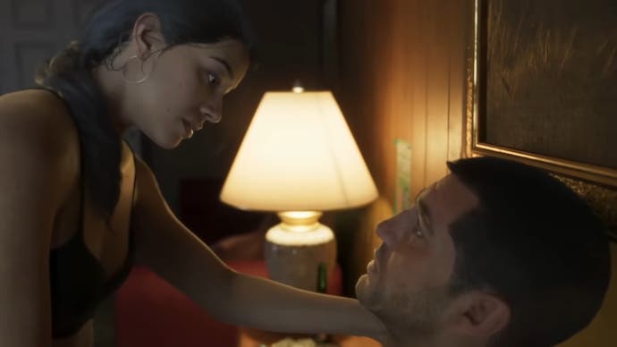GTA 6 screenshot showing Julia looking intimately at Jason in a motel bed.