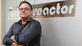 Bit Reactor's Greg Foertsch standing in front of their company logo