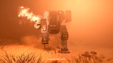 Helldivers 2 trailer screenshot showing mech with machine gun emerging from sandy haze