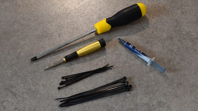 The tools you'll need to build a PC: crosshead screwdrivers, thermal paste, and cable ties.