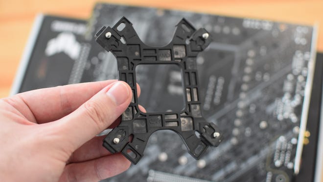 Step 1 of how to install a CPU air cooler: assemble the backplate.