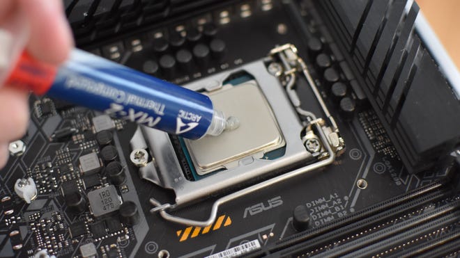 Step 3 of how to install a CPU liquid cooler: apply thermal paste to the CPU.