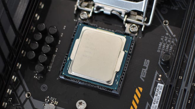 Step 2b of how to install a CPU: place the processor inside the socket, so that it sits snug and level.
