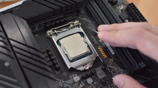 Step 3 of how to install a CPU: secure the CPU inside the socket by closing any metal covers and lowering the adjacent lever.