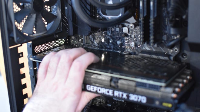 Step 3 of how to install a graphics card (GPU): Push the graphics card into the PCIe x16 slot until the retention clip snaps back into place.