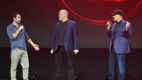 Charlie Cox, Vincent D'Onofrio, and Kevin Feige standing on stage at D23