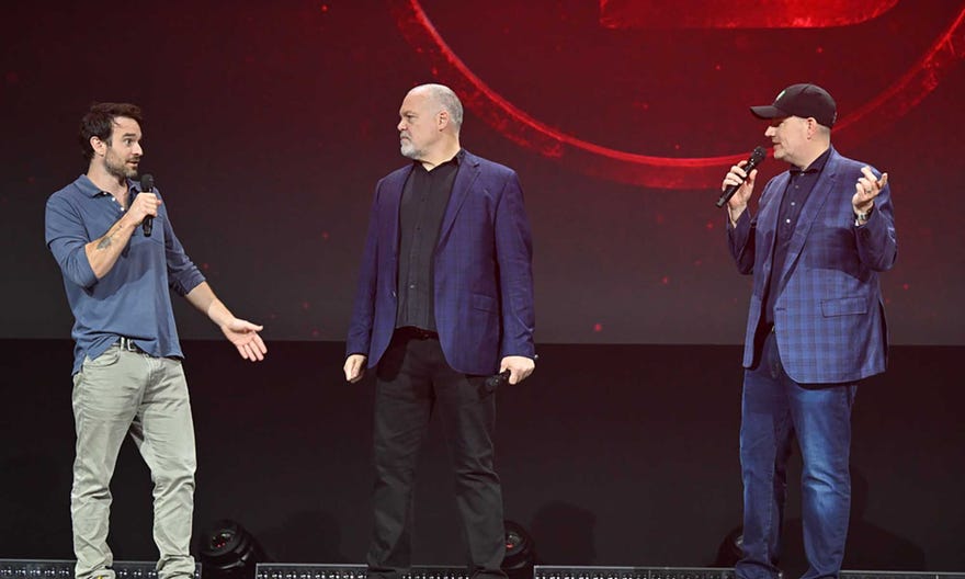 Charlie Cox, Vincent D'Onofrio, and Kevin Feige standing on stage at D23