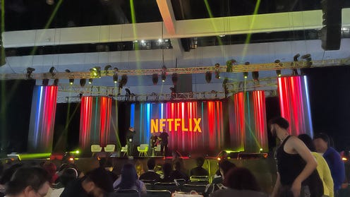 Photograph of a stage at Anime Expo with screens displaying the Netflix logo